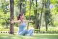 Sport woman breathing deeply fresh air with arms raised outdoor in park Royalty Free Stock Photo