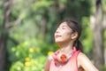 Sport woman breathing deeply fresh air in a forest with blurred green background Royalty Free Stock Photo