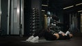 Sport woman Caucasian fit girl sportswoman athlete trainer exercising on fitness mat in dark gym training with equipment Royalty Free Stock Photo