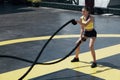 Sport woman doing battle ropes exercise workout at gym Royalty Free Stock Photo