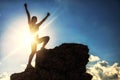 sport woman raise hands at mountain summit