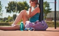 Sport woman relaxing after workout at the stadium, runner taking break after running sport. Royalty Free Stock Photo