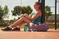 Sport woman relaxing after workout at the stadium, runner taking break after running sport. Royalty Free Stock Photo