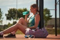 Sport woman relaxing after workout at the stadium, runner taking break after running sport. Royalty Free Stock Photo