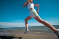 Sport woman running on beach
