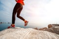 Sport woman running on the rocky beach Royalty Free Stock Photo