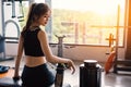 Sport woman sitting and resting after workout or exercise in fitness gym with protein shake or drinking water on floor. Relax Royalty Free Stock Photo