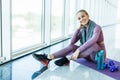 Sport woman sitting and resting after workout or exercise in fitness gym with protein shake or drinking water on floor. Relax Royalty Free Stock Photo