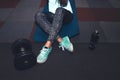 Sport woman sitting and resting after workout or exercise in fitness gym with protein shake or drinking water on floor Royalty Free Stock Photo