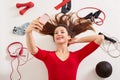 Sport woman smiling at camera of her moderm cell phone, making self picture at gym while laying on floor, young girl being at Royalty Free Stock Photo