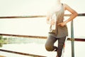 sport woman standing after running with hand holding water bottle at park Royalty Free Stock Photo