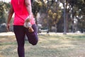 Sport woman stretching leg muscle preparing for running in the public park outdoor. Close up of female athlete lower body doing Royalty Free Stock Photo