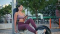 Sport woman watching mobile phone spinning pedals exercise machine at park gym Royalty Free Stock Photo