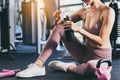 Sport woman workout at fitness center with relax and taking a break Beautiful girl drinking protein shake holding protein shake Royalty Free Stock Photo