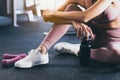 Sport woman workout at fitness center with relax and taking a break Beautiful girl holding protein shake bottle after exercise at Royalty Free Stock Photo