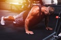 Sport young athletic man doing push-up. Muscular and strong guy exercising at a gym.Strength and motivation concept Royalty Free Stock Photo