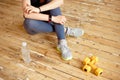 Sport young female at gym taking a break from workout and dumbbell were placed nearby. Royalty Free Stock Photo