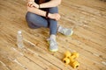 Sport young female at gym taking a break from workout and dumbbell were placed nearby. Royalty Free Stock Photo