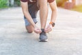 Sport young man laces his shoes on the road Royalty Free Stock Photo