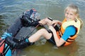 Sportin child riding on a wakeboard on the lake