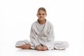 Sporting girl in keikogi sits on the floor, white background