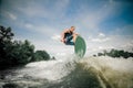 Wakeboarder rides up the wake