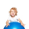 Sportive baby playing with fitness ball. Royalty Free Stock Photo