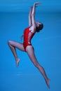 Sportive brunette woman in red swimsuit