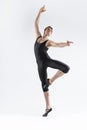 Sportive Caucasian Male Ballet Dancer Flexible Athletic Man Posing in Black Tights in Ballanced Dance Pose With Hands and Leg