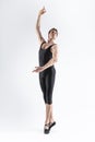 Sportive Caucasian Male Ballet Dancer Flexible Athletic Man Posing in Black Tights in Ballanced Dance Pose With Hands Lifted