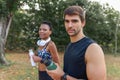 Sportive couple looking at camera in morning park Royalty Free Stock Photo