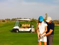 Sportive couple playing golf on a golf course Royalty Free Stock Photo