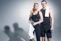 Sportive couple standing with towels and water bottles Royalty Free Stock Photo