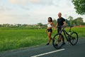 Sportive Couple Walking Bike On Road. Asian Woman And Caucasian Man Walking By Hands With Bicycles And Talking.