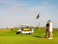 Sportive family playing golf on a golf course