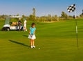 Sportive family playing golf on a golf course Royalty Free Stock Photo
