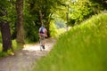 Sportive man cycling in sunny park in hot summer day. Switzerland, Europe