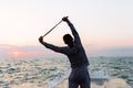 Sportive man doing exercises, standing on pier Royalty Free Stock Photo