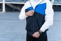 Sportive man zips up sportswear jacket prepare to training Royalty Free Stock Photo