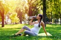 Sportive pregnant woman drinking water in park Royalty Free Stock Photo