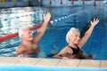 Sportive senior couple doing exercises in indoor