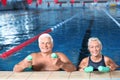 Sportive senior couple with swimming noodles