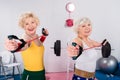 sportive senior ladies exercising with resistance bands and smiling Royalty Free Stock Photo