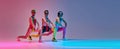 Sportive, serious man in funny sportswear stretching, training against gradient blue pink studio background in neon