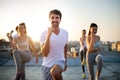 Group of athletic young people, friends in sportswear doing exercises. Sport outdoors Royalty Free Stock Photo