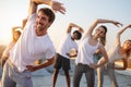 Group of athletic young people, friends in sportswear doing exercises. Sport outdoors Royalty Free Stock Photo