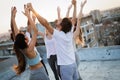 Group of athletic young people, friends in sportswear doing exercises. Sport outdoors Royalty Free Stock Photo