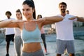 Group of athletic young people, friends in sportswear doing exercises. Sport outdoors Royalty Free Stock Photo