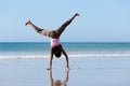 Sportive woman doing gymnastics on the beach Royalty Free Stock Photo