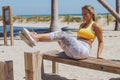 Sportive woman exercising on beach in gym Royalty Free Stock Photo